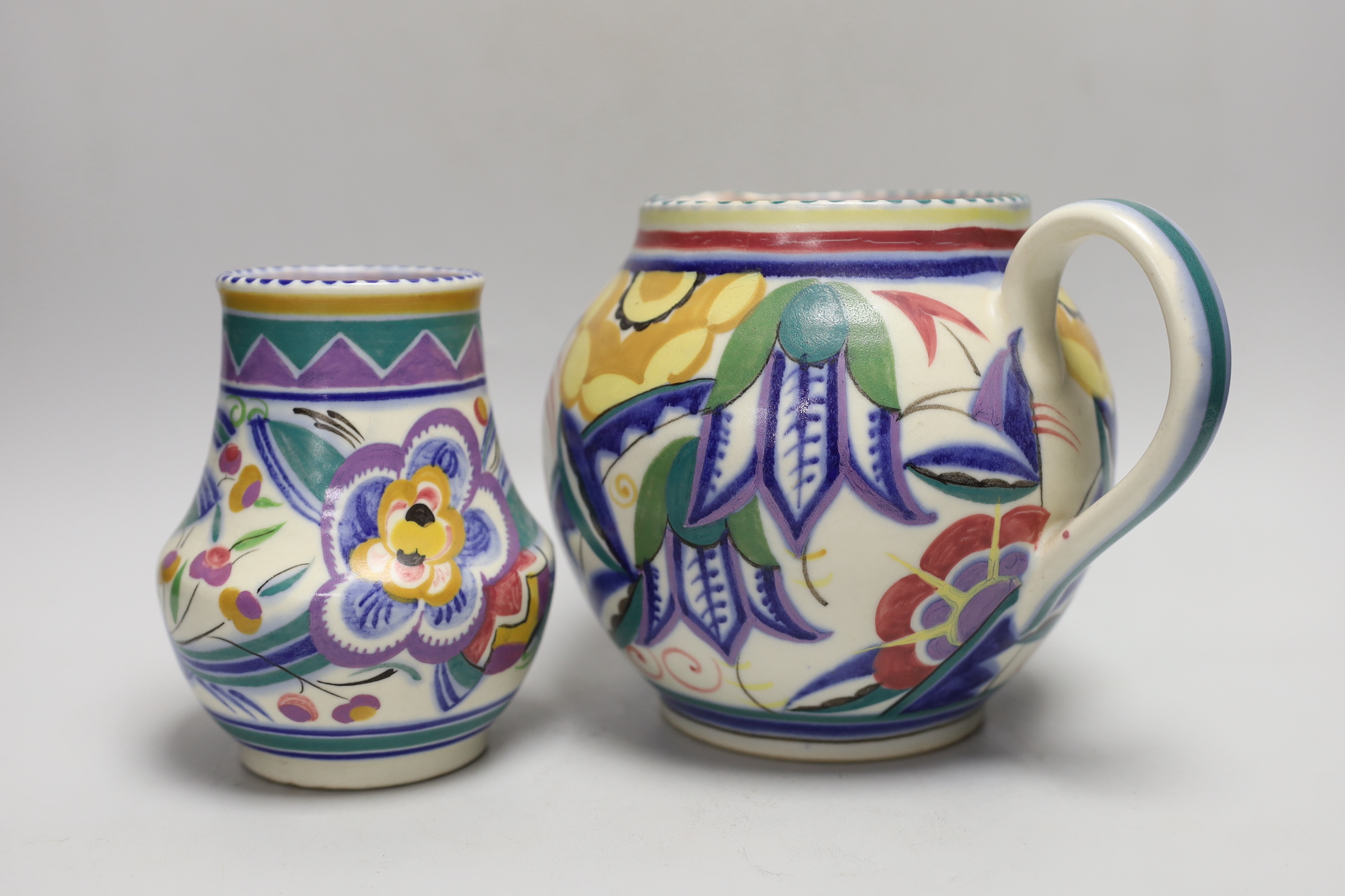 A 1930’s Poole Pottery polychrome jug and vase, jug 16cm